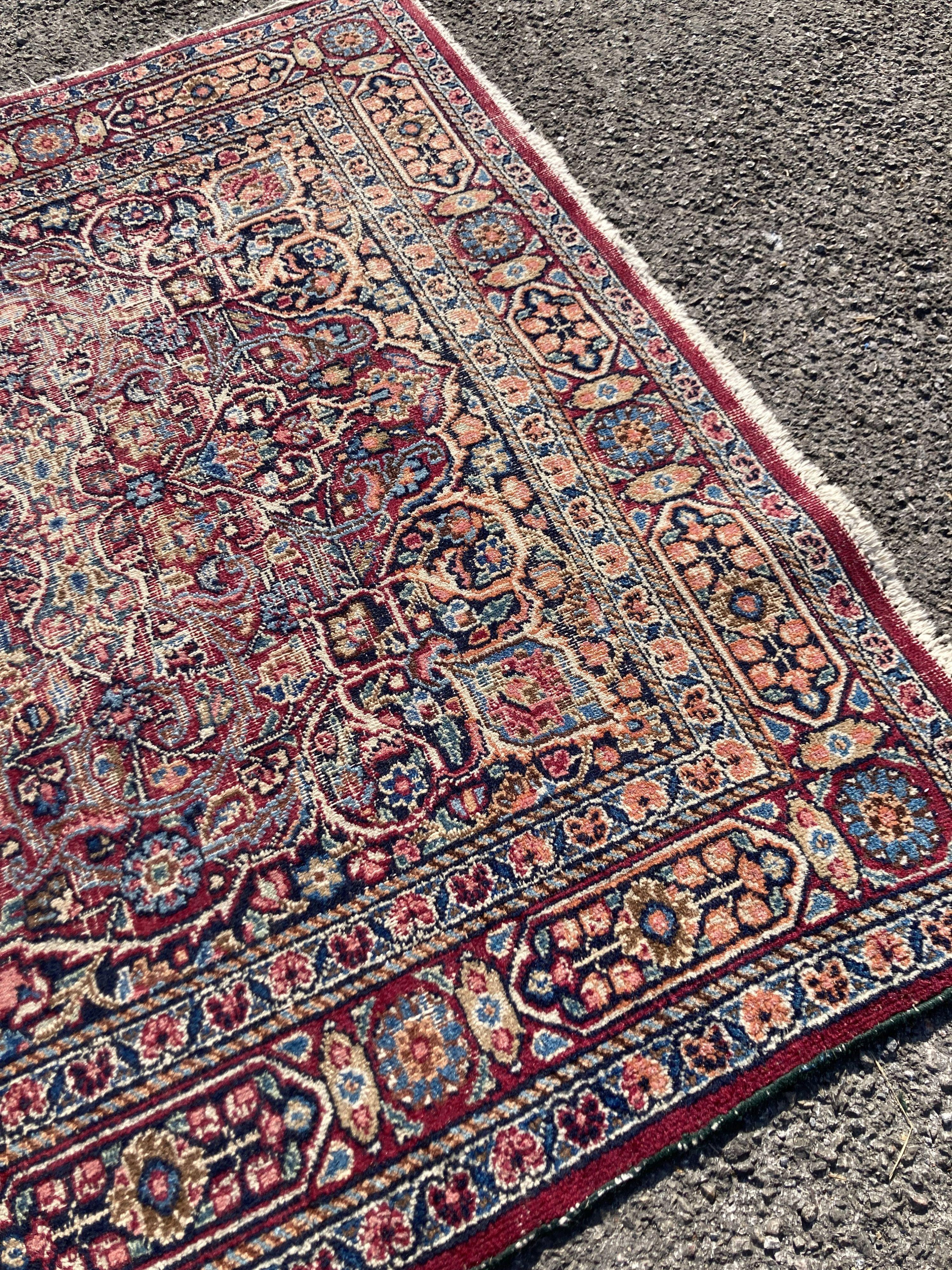 A North West Persian red ground rug (worn), 127 x 76cm